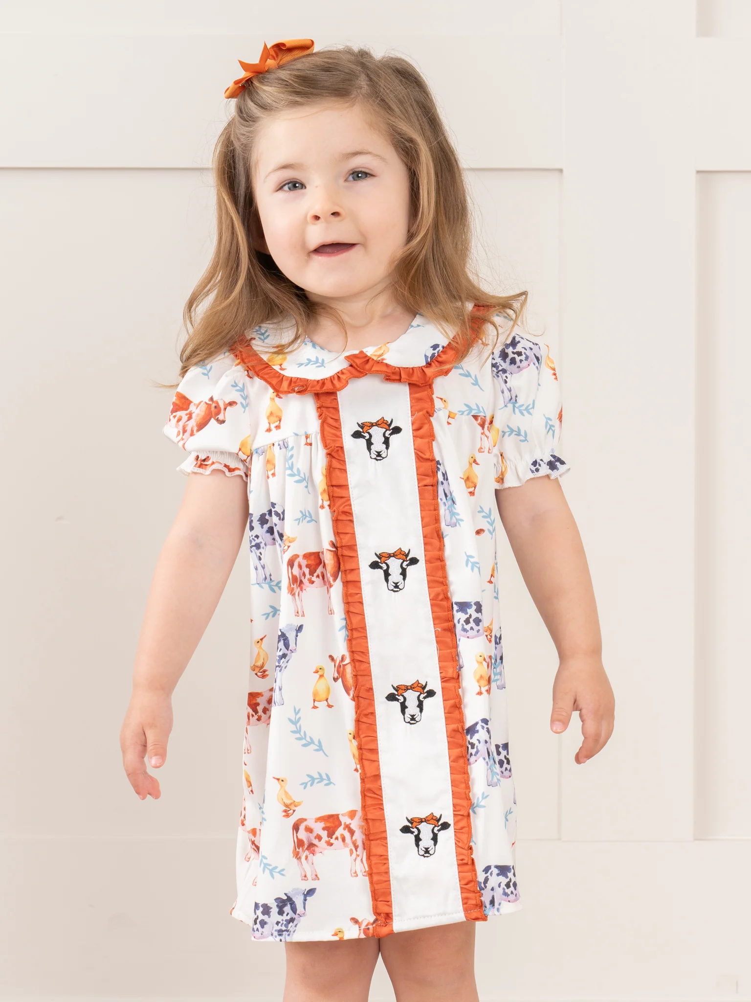 Cream & Bronze Embroidered Cow Ruffle Dress